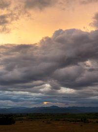 Scenic view of dramatic sky over land