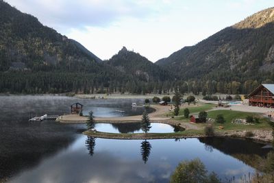 Scenic view of lake and mountains against sky