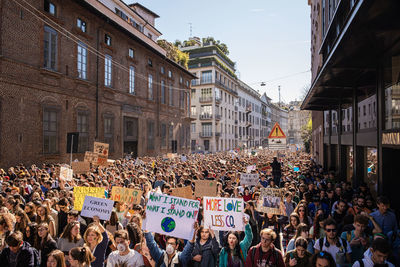 People on street amidst buildings in city