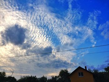 Low angle view of building against cloudy sky