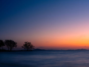 Scenic view of sea against orange sky