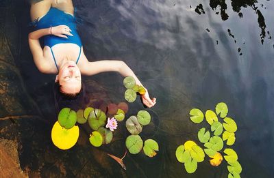 High angle view of mid adult woman relaxing in lake