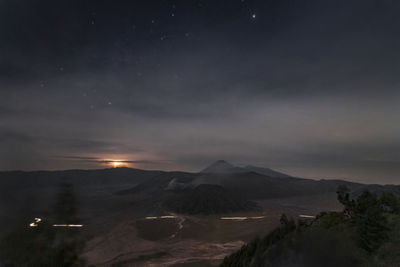 Scenic view of landscape against sky at night