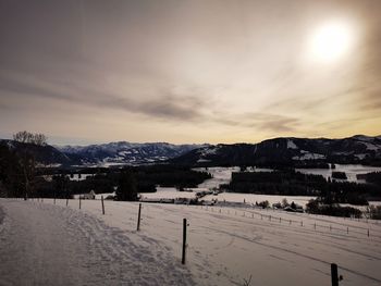 Scenic view of snow covered landscape against sky