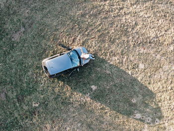 High angle view of abandoned car on field