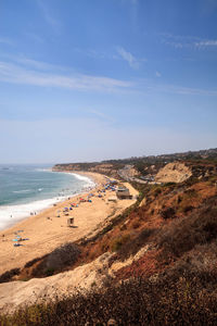 Scenic view of beach against blue sky