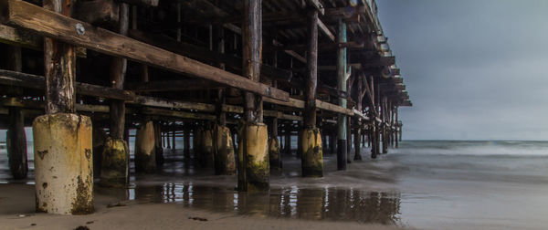 Pier over sea against sky