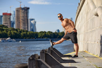 Low angle view of young man sitting on steps