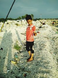 Full length of boy standing on ground