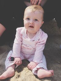 Portrait of cute girl sitting outdoors