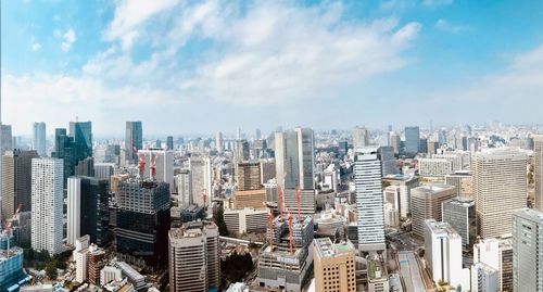 Aerial view of modern buildings in city against sky