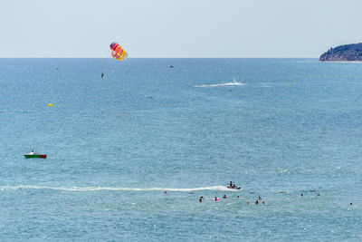 People on beach against sky