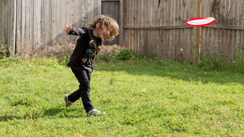 Full length of boy standing on grass