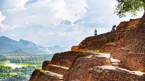 View of old ruins on mountain against sky