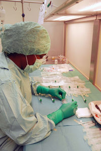 Close-up of doctor holding syringe on table