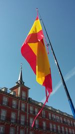 Low angle view of flags against clear sky