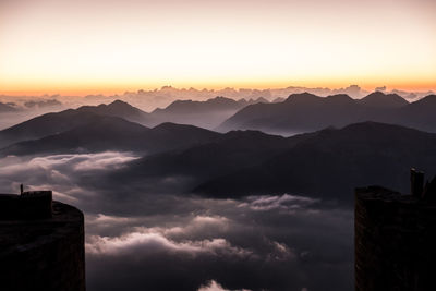 Scenic view of silhouette mountains against sky during sunset