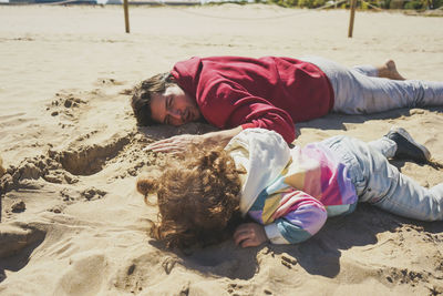 Full length of woman relaxing at beach