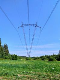 Electricity pylon on field against sky