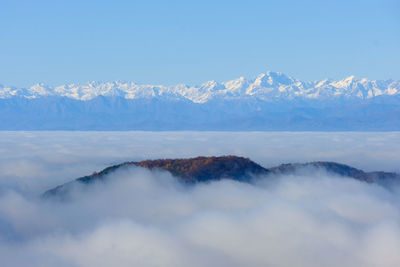 A sea of fog over the city of como and lake como, from a panoramic viewpoint in brunate.