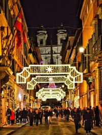 People on illuminated city at night