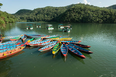 Multi colored boats moored in lake