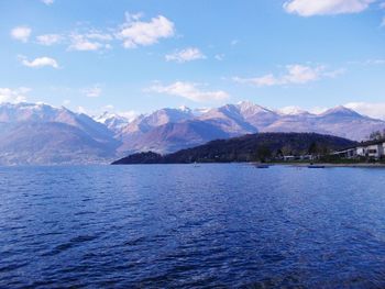 Scenic view of mountains and sea against cloudy sky