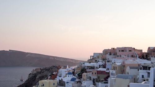 High angle view of townscape by sea against sky