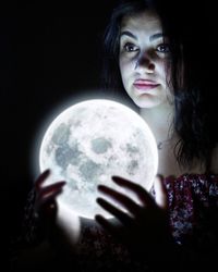 Close-up portrait of young woman holding camera