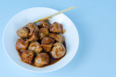 High angle view of food in plate on white background