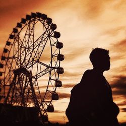 Low angle view of ferris wheel against sky