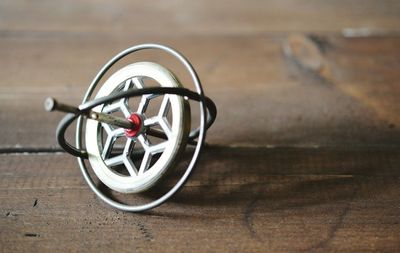 Close-up of gyroscope on wooden table