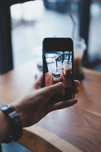 Midsection of man using mobile phone