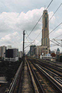 View of railroad tracks against cloudy sky