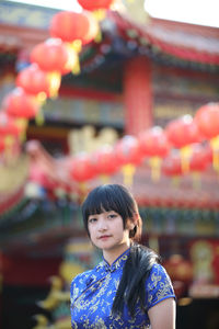 Portrait of a young woman standing outdoors