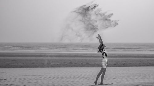 Woman standing on the beach