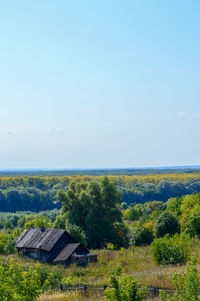 Scenic view of trees and houses against sky