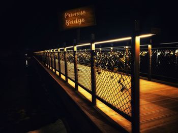 Illuminated text on footpath at night