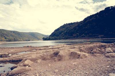 Scenic view of lake against cloudy sky