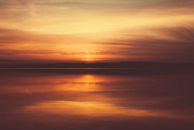 Scenic view of sea against romantic sky at sunset