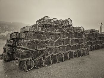 Close-up of fishing net on land against sky