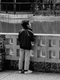 Rear view of boy standing outdoors