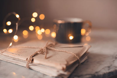 Laced old romantic handwritten paper letters with cup of coffee and glow lights at background