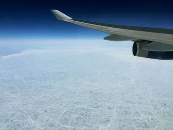 Aerial view of snowcapped mountain against sky