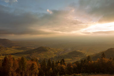 Scenic view of landscape against sky at sunset