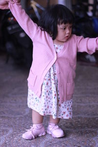 Full length of cute girl with pink petals