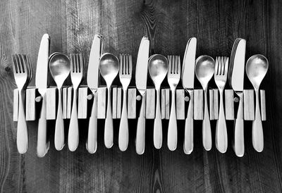 Directly above shot of cutlery in rack on table