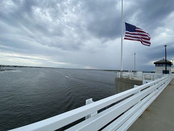 Flag on sea against sky