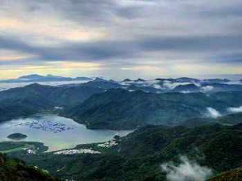 Scenic view of mountains against cloudy sky