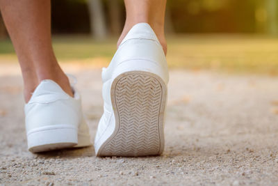 Low section of woman walking outdoors